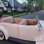 Vintage cream convertible parked on suburban street