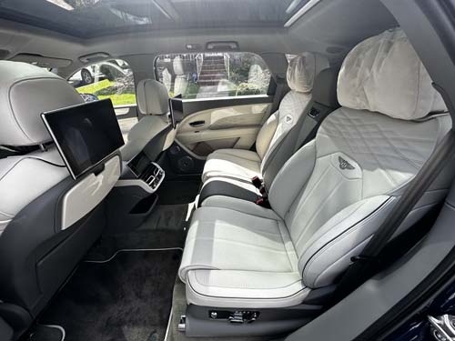 Luxury car rear seats with white leather interior
