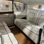 White leather seating inside classic boat cabin