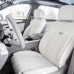 Modern car interior with white leather front seats