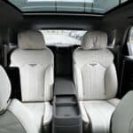 Luxury car interior with white leather seats and sunroof