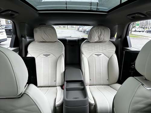 Luxury car interior with white leather seats and sunroof