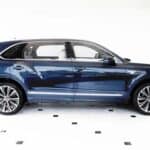 Blue luxury SUV side view in showroom