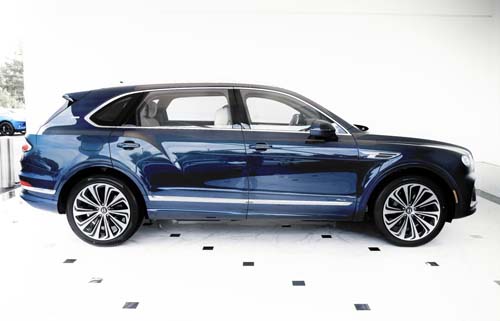 Blue luxury SUV side view in showroom