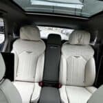 Luxury car rear seats with white leather interior