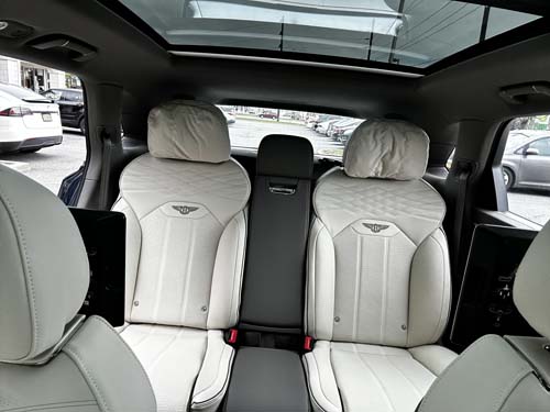 Luxury car rear seats with white leather interior