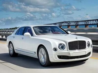 White luxury sedan driving on bridge highway