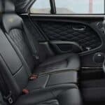 Luxury car rear seats with black leather interior