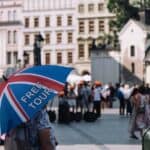 Free tour umbrella in crowded city square