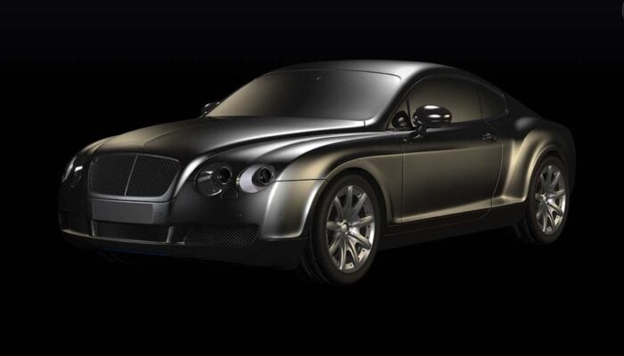 Black luxury sports coupe on dark background