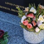 Flower bouquet on engraved gravestone memorial