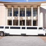 White stretch limousine parked in front of columned building