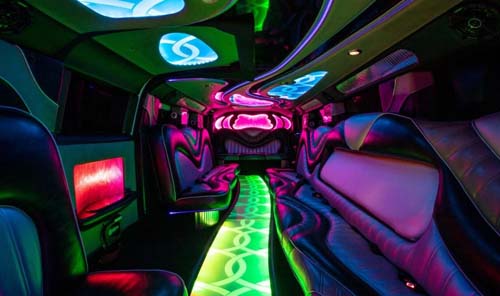 Neon-lit luxury limousine interior with colorful LED lighting