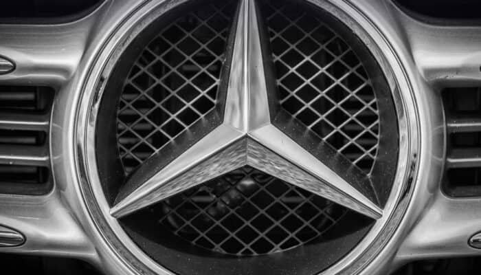 Close-up of Mercedes-Benz emblem on car grille