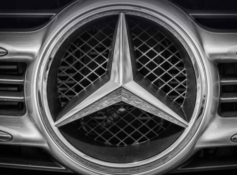 Close-up of Mercedes-Benz emblem on car grille