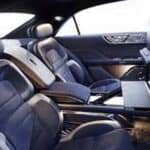 Luxury car interior with leather seats and fold-out table