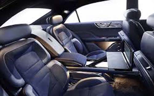 Luxury car interior with leather seats and fold-out table