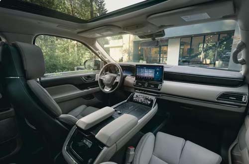 Modern car interior with touchscreen dashboard and sunroof