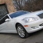 White Mercedes-Benz sedan parked near garage door