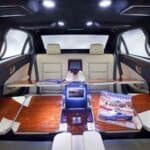 Luxury car interior with fold-out tables and magazines