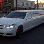 White stretch limousine parked on city street
