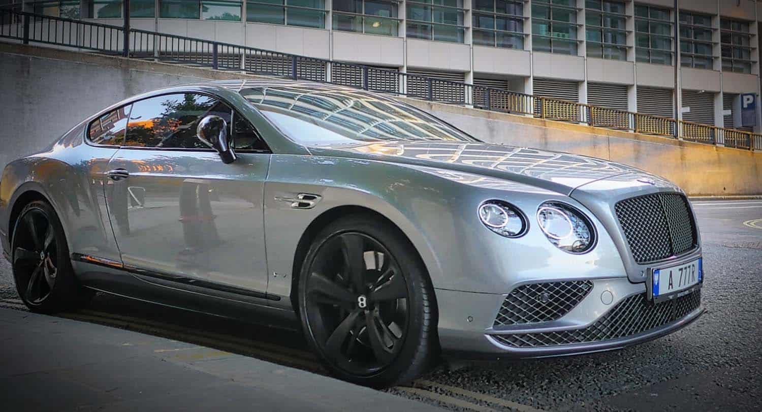 Silver Bentley Continental GT parked on city street