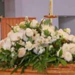 White funeral flowers on church altar
