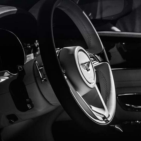 Luxury car interior with Bentley steering wheel
