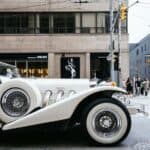 Vintage white luxury car at city intersection