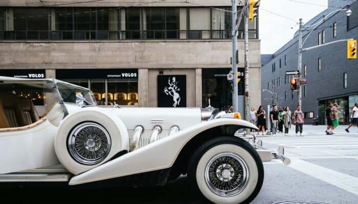 Vintage white luxury car at city intersection