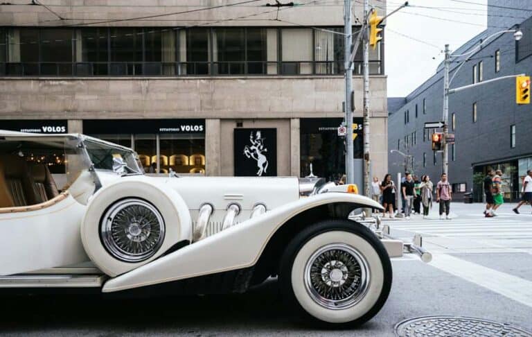 Vintage white luxury car at city intersection