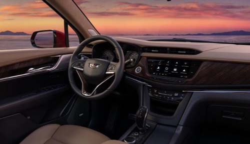 Car interior with steering wheel and sunset view
