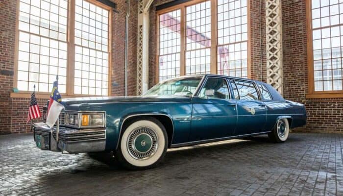 Vintage presidential limousine inside brick industrial building