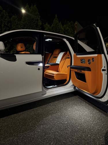 Luxury car with orange leather interior at night