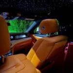 Luxury car interior with tan leather and starlit ceiling