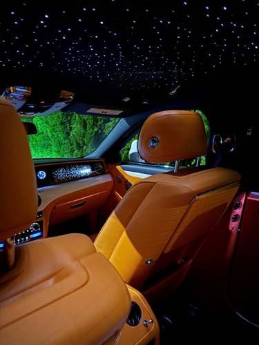 Luxury car interior with tan leather and starlit ceiling