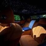 Luxury car interior with orange leather and starlit ceiling