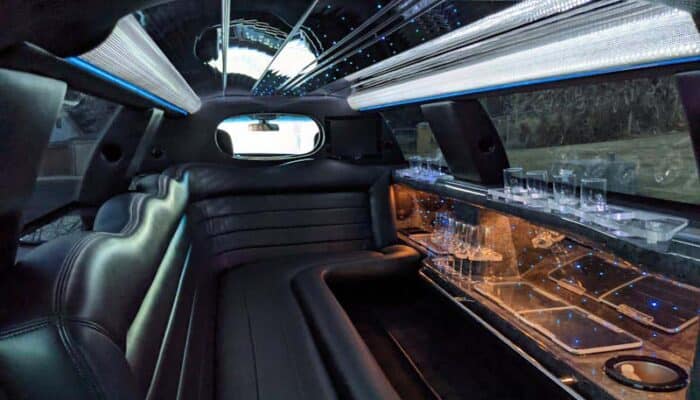 Luxury limousine interior with leather seats and bar