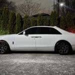 White luxury sedan parked at night