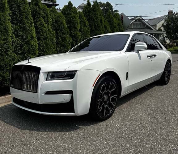 White Rolls-Royce sedan parked on residential street