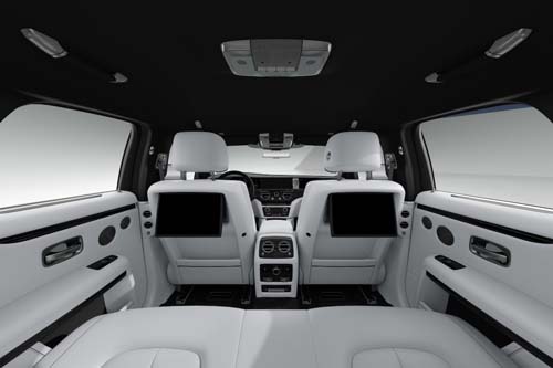 Luxury SUV interior with white leather seats and screens