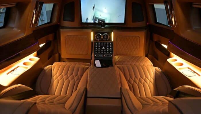 Luxury car rear cabin with leather seats and screen