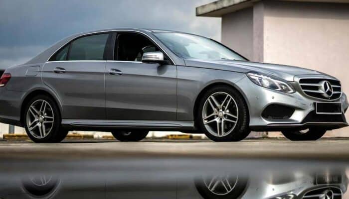 Silver Mercedes-Benz sedan parked with reflection