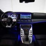 Modern car interior with blue ambient lighting dashboard