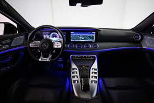 Modern car interior with blue ambient lighting dashboard