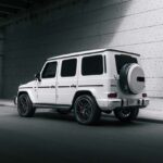 White Mercedes-Benz G-Wagen parked in a concrete tunnel.