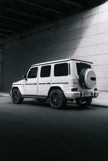 White Mercedes-Benz G-Wagen parked in a concrete tunnel.