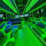 Neon green-lit interior of a luxury party bus
