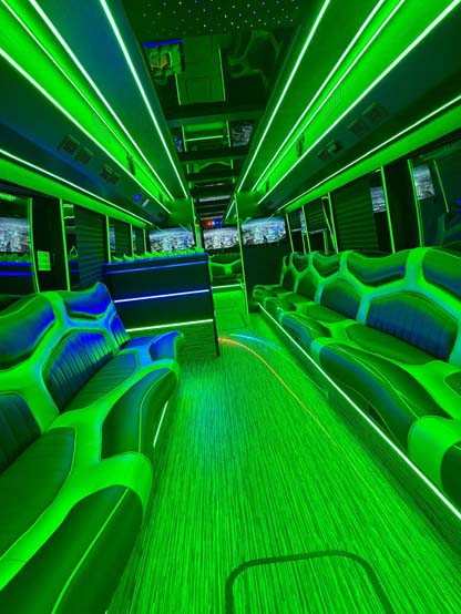 Neon green-lit interior of a luxury party bus