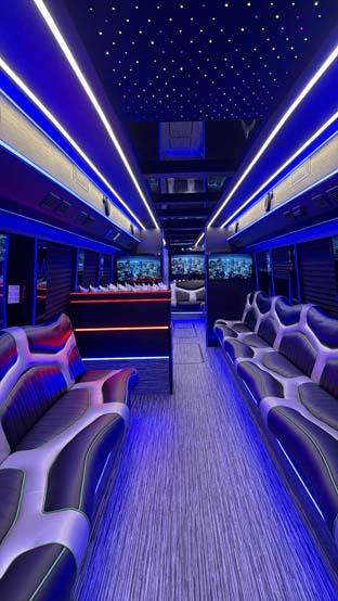 Luxurious party bus interior with blue lights and leather seats